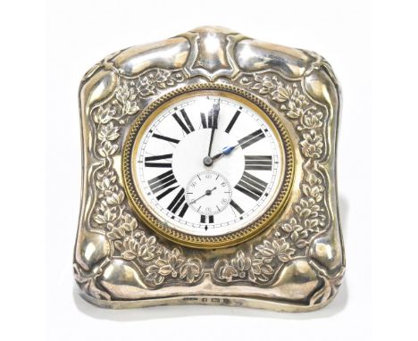 DOUGLAS CLOCK CO; an Edward VII hallmarked silver mounted easel back travelling clock, with cast repoussé decoration, housing