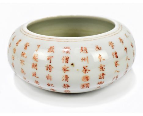 A Chinese porcelain bowl with curved rim, painted in iron red with various character marks, bearing four character marks to i