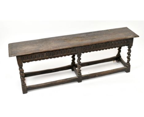 An 18th century oak rectangular bench of joined construction in the manner of a joint stool, the rectangular seat length 138c