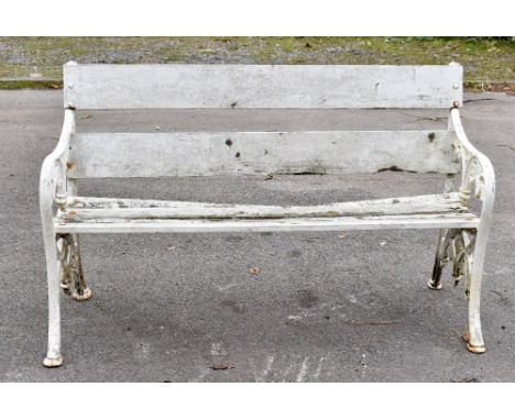 A white painted cast iron garden bench with slated wooden seat, width 132cm.