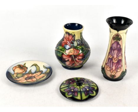 MOORCROFT; four pieces of ceramics comprising a waisted vase decorated in the 'Foxglove' pattern, a further baluster vase dec