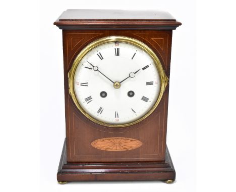 An Edwardian inlaid mahogany mantel clock of rectangular form, the enamel dial set with Roman numerals and quarterly Arabic n