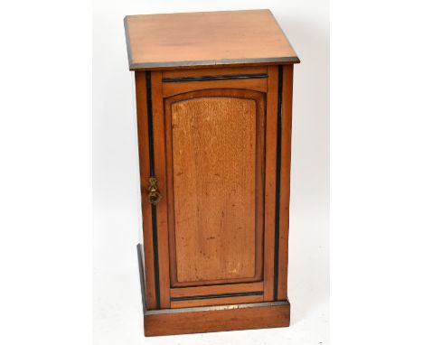 A Victorian light walnut pot cupboard, with panelled door, on plinth base