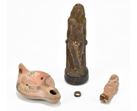 A Roman terracotta oil lamp, relief decorated with a running hound, length 13.5cm, a naïve Shabti figure, height 9cm, a small