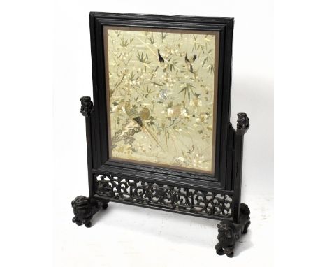 A Chinese carved hardwood fire screen, with associated panel with embroidered insert, height 72cm.Additional InformationThe s