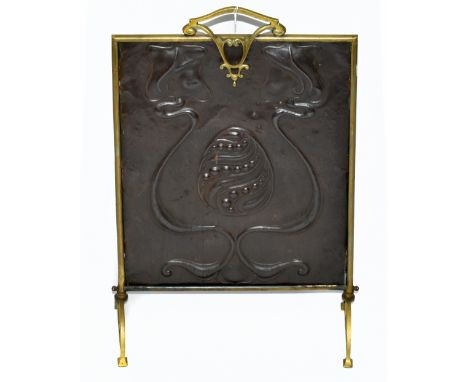 An Arts &amp; Crafts brass framed fire screen with sheet copper central panel with embossed scrolling/floral decoration, heig