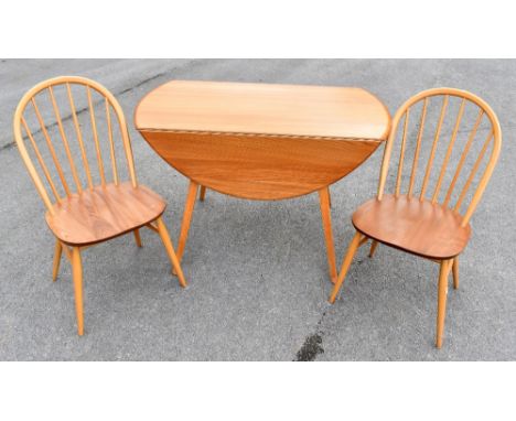 ERCOL; a light elm drop-leaf dining table and four chairs, the table height 72cm, length 103cm.&nbsp;