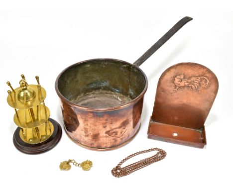 A 19th century copper and wrought iron saucepan, diameter 26.5cm, with an Arts and Crafts type wall bracket decorated with a 