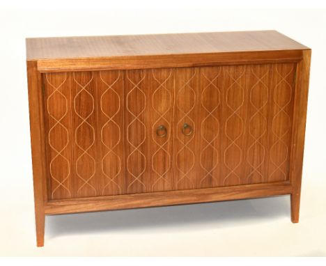 GORDON RUSSELL; a double helix sideboard with twin cupboard doors, raised on short tapering legs, bearing maker's plaque and 