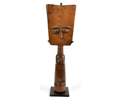 A Fanti doll, Akan, Ghana, the light wood carving formed as a stylised female with typical enlarged square head, height 32cm.