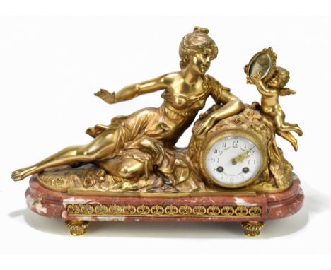 A late 19th century French gilt spelter figures mantel clock, modelled as a maiden with a cherub holding a mirror, height 32c