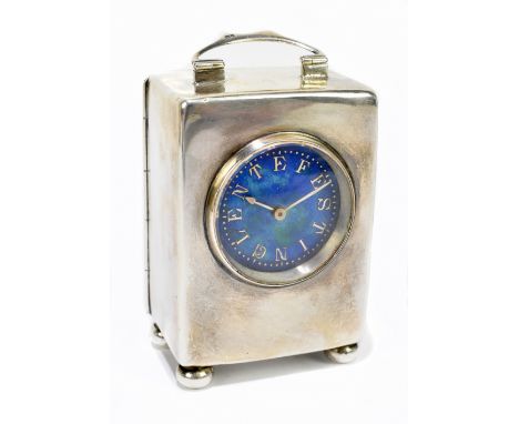 LIBERTY & CO; an Edwardian hallmarked silver and enamel decorated velvet cased travelling clock, with swing loop handle above