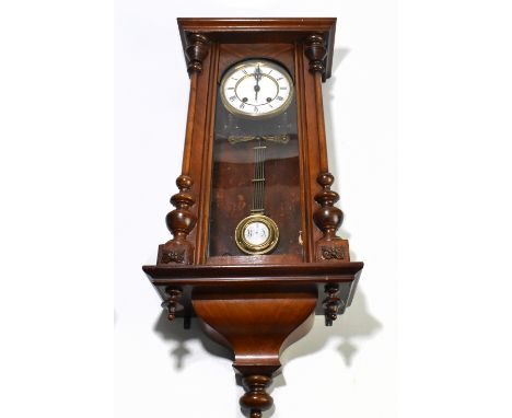An early 20th century rosewood and stained Vienna style wall clock, the circular dial set with Roman numerals, height 73cm.