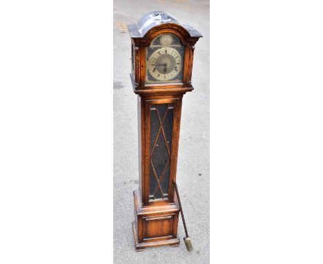 A 1950s oak cased longcase clock of small proportions, the silvered dial inscribed ‘Tempus Fugit’ with applied chapter ring b