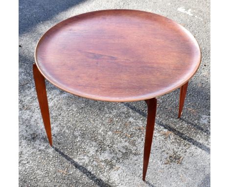 FRITZ HANSEN; a Danish teak circular occasional table on folding, height 42cm, diameter 59.5cm.Additional InformationA little