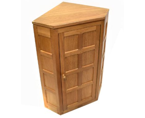 DAVID (OAKLEAFMAN) LANGSTAFF; a light oak hanging corner cupboard, the single panelled door enclosing fixed shelves, height 9