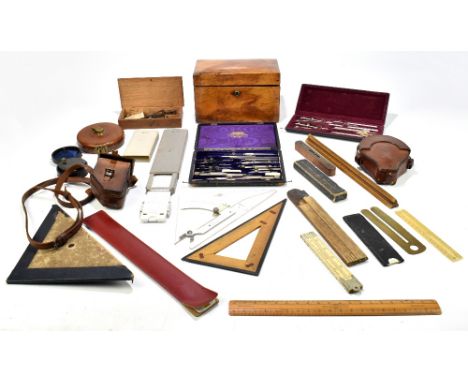 A 19th century walnut tea caddy of shaped rectangular form, width 22cm, together with a collection of writing implements and 