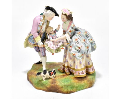 JEAN GILLE; a late 19th century painted bisque figure group representing a man and lady supporting their child above dog, on 