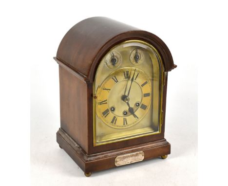 An early 20th century mahogany mantel clock, the brass dial applied with chapter ring bearing Roman numerals, with two subsid