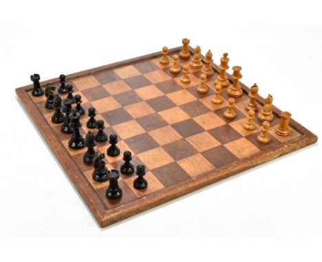 An early 20th century boxwood and ebonised Staunton pattern chess set, unmarked, height of King 8cm, an inlaid chess board, a