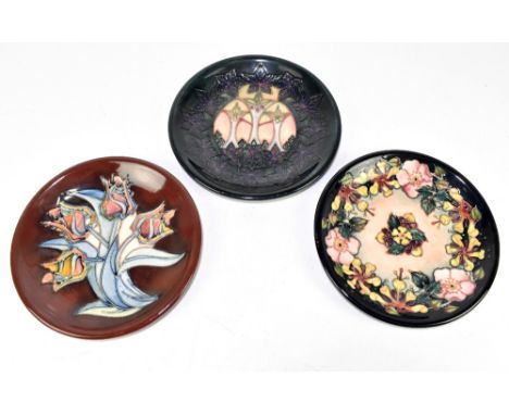 MOORCROFT; three ceramic wall plates, various patterns including 'Red Tulip' and 'Oberon', diameter 25cm (3).&nbsp;Additional