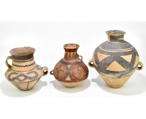 A group of three Chinese Neolithic period (circa 2nd Millennium BC) late Yangshao Culture buff red earthenware vessels with p