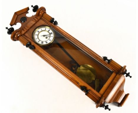 A late 19th century rosewood Vienna style wall clock, with ebonised finials above the circular dial set with Roman numerals, 