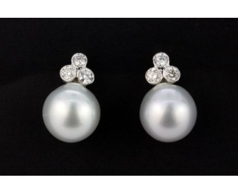 A pair of 18ct white gold (stamped 750) earrings set with South Sea pearls and brilliant cut diamonds, approx. 0.85ct overall