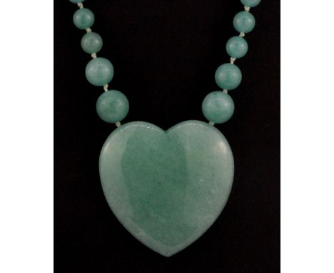 A polished jade bead necklace, L. 40cm.