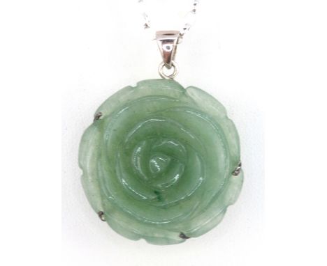 A carved jade flower shaped pendant on a 925 silver chain.