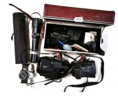 A Minolta single lens reflex camera and other photographic equipment.