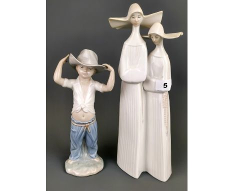 A large Lladro figure of two nuns, H. 33cm. Together with a Nao figure of a boy in a cowboy hat. Condition: no visible damage