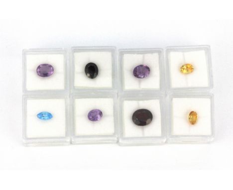 Eight individually boxed unmounted gemstones, including garnet, amethyst, ruby, citrine, etc.