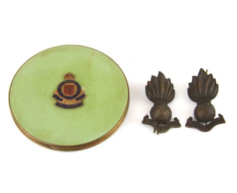 A Royal Army Ordinance Corps sweetheart compact and two cap badges.