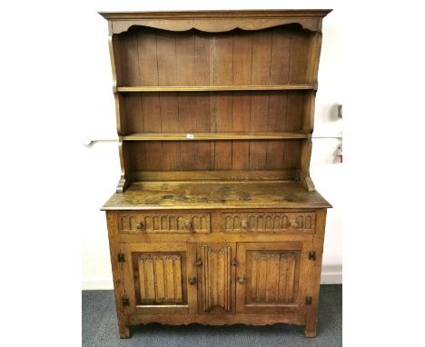 A 1930's oak linen fold Welsh dresser, W. 121cm, H. 184cm.