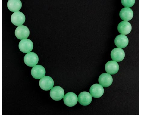 A jadeite jade polished bead necklace, L. 50cm.
