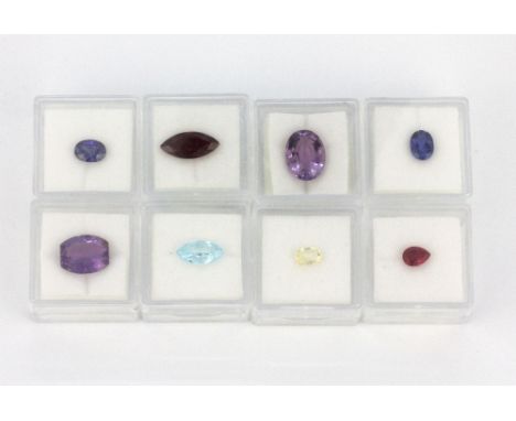 Eight individually boxed unmounted gemstones, including garnet, ruby, amethyst, sapphire, citrine, etc.