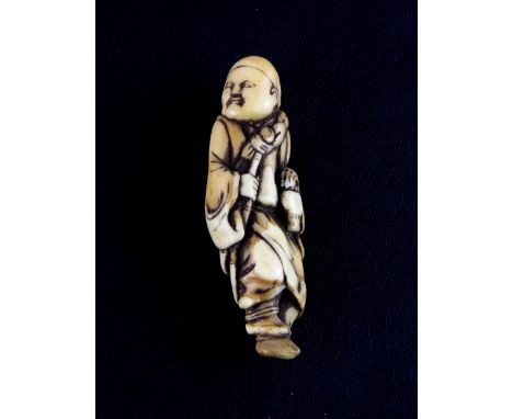 A 19th Century Japanese carved ivory netsuke of a man with a monkey on his back, H. 5.5cm.