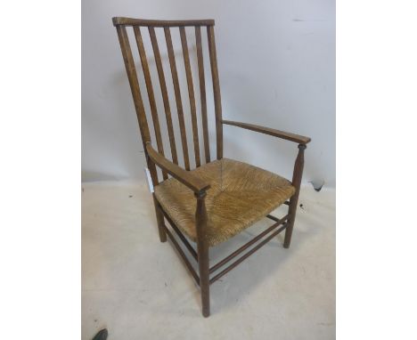 A late 19th / early 20th century ladder back chair with rush seat, raised on tapering legs joined by stretchers 