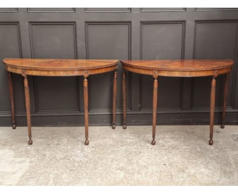 A large pair of circa 1900 figured mahogany demi-lune console tables, with segmented veneer tops and stop fluted legs, 122cm 