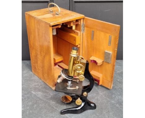 An Ernst Leitz microscope, No.272153, with various eyepieces, boxed.