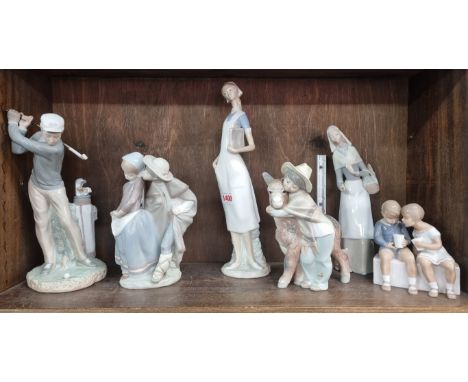 Five Lladro figures, largest 35.5cm high, (repaired chip to donkey's ear); together with a Bing and Grondahl figure group, 13