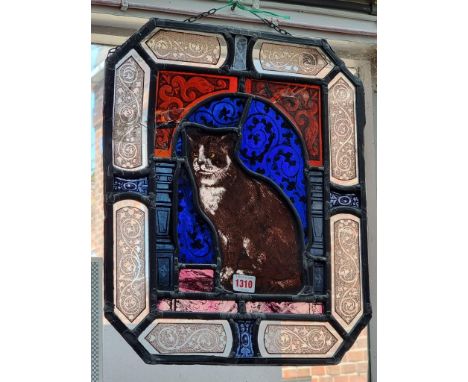 A stained and leaded glass panel of a cat, 45.5 x 38cm, (cracks).