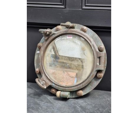 A bronze porthole mirror, 44cm wide.