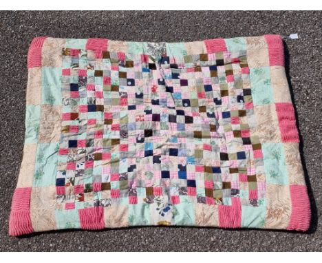 A small patchwork quilt, 124 x 95cm.