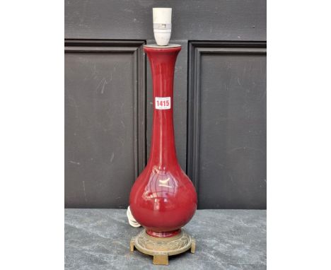 A Chinese Sang de boeuf table lamp, with brass foot, total height 48cm.