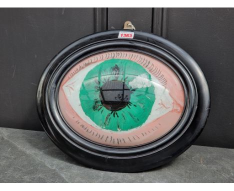 Folk Art: a rare 19th century reverse glass painted optometrist's eye sign, probably French, of domed form, 19 x 25.5cm oval,