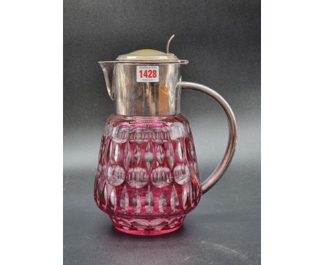 A cranberry overlay glass and electroplate mounted lemonade jug, 28cm high.