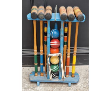 A polychrome painted croquet set. 