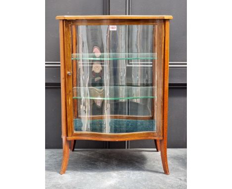A small Edwardian mahogany and line inlaid vitrine, of serpentine outline, 78.5cm high x 55.5cm wide x 39.5cm deep.
